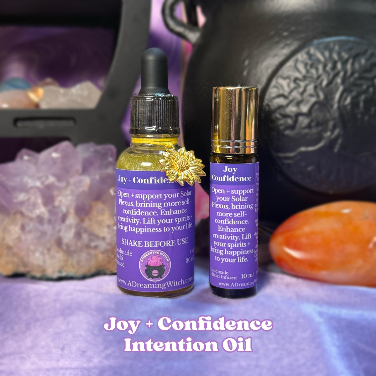 Two bottles of 'Joy + Confidence' intention oil with crystals and a black cauldron in the background.