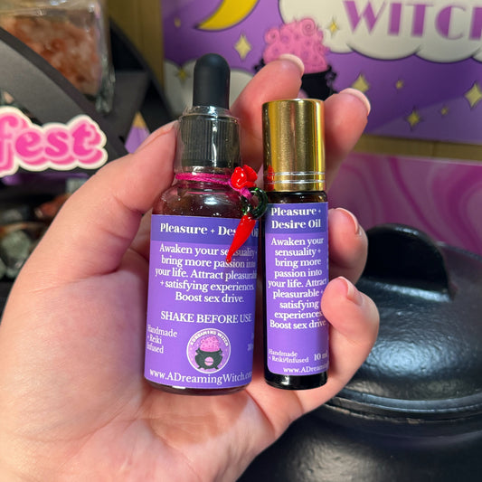 Hand holding two purple bottles labeled 'Pleasure Desire Oil' with a colorful background.