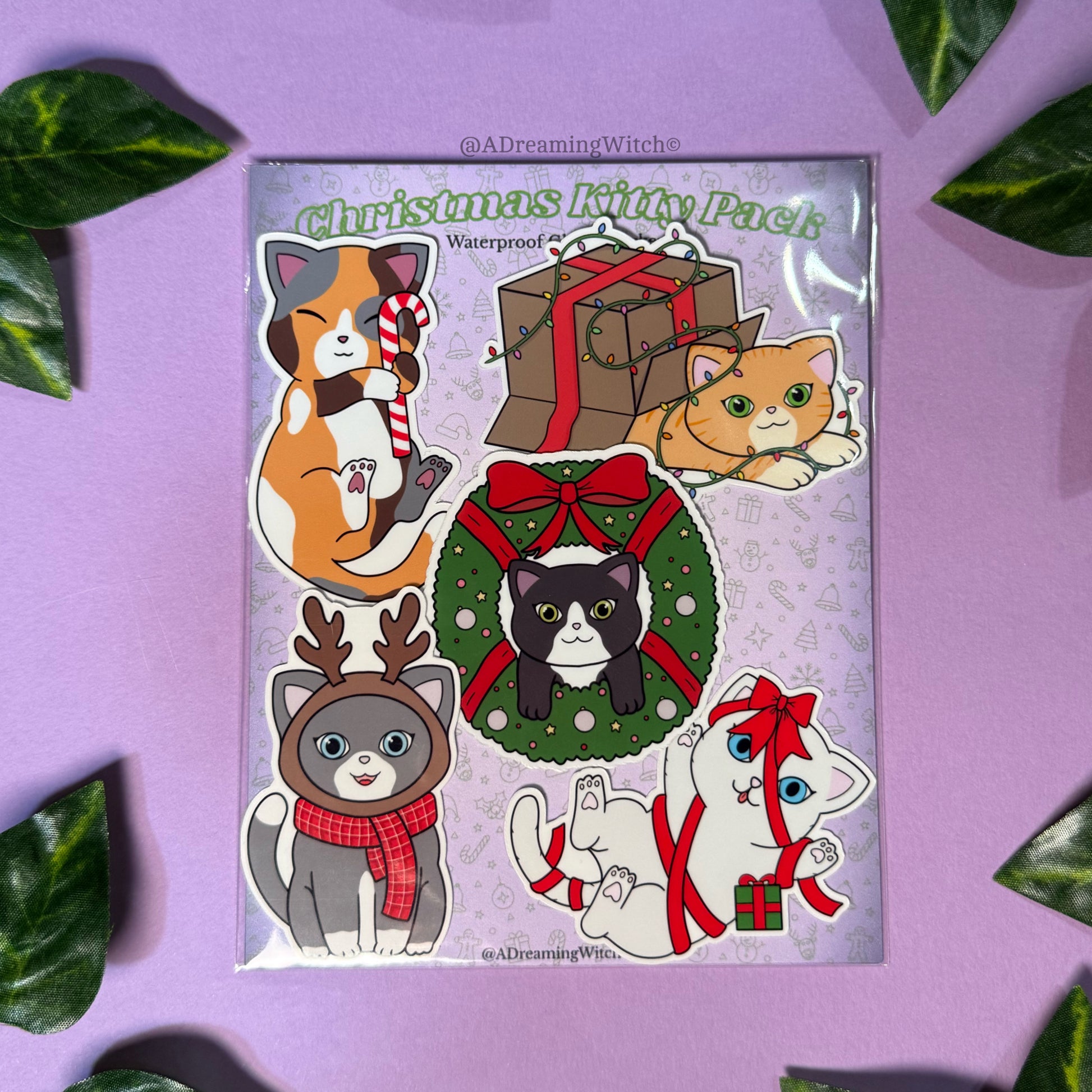 Christmas-themed sticker pack with cats on a purple background