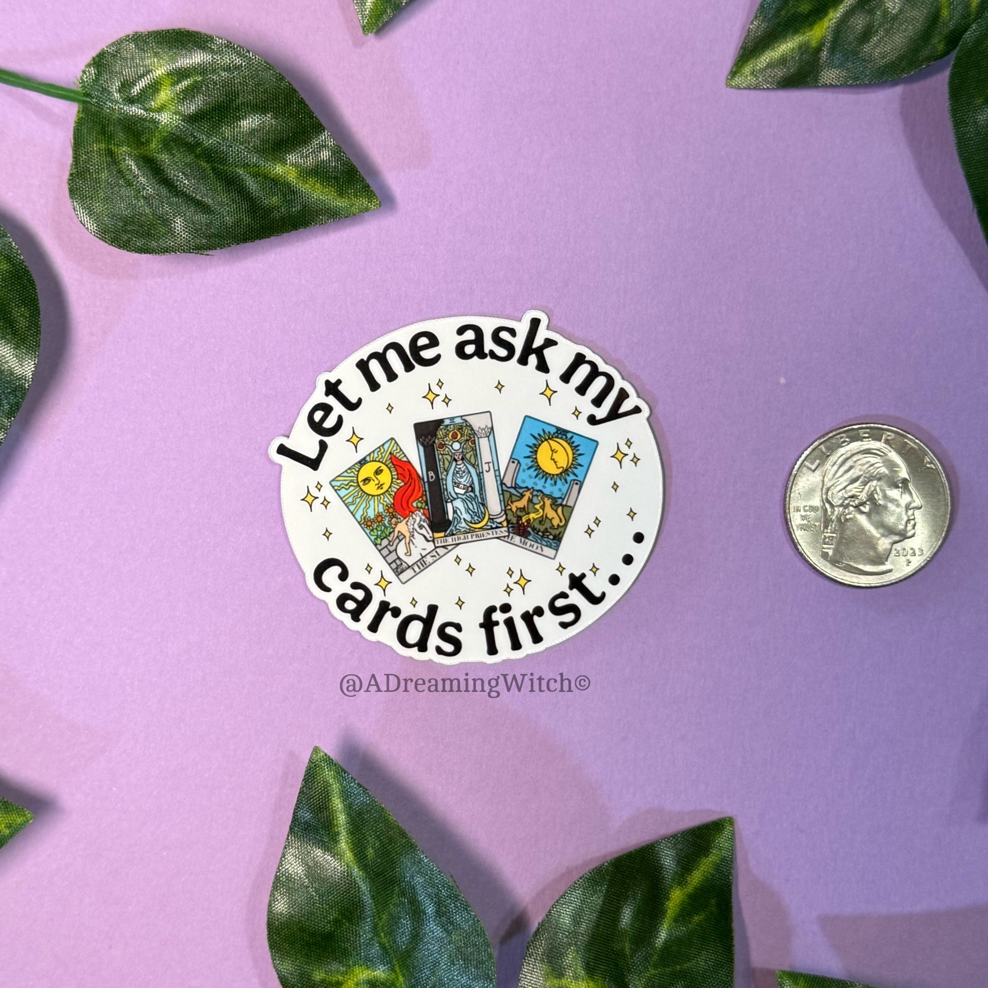 Sticker with tarot card design and text on a purple background with leaves