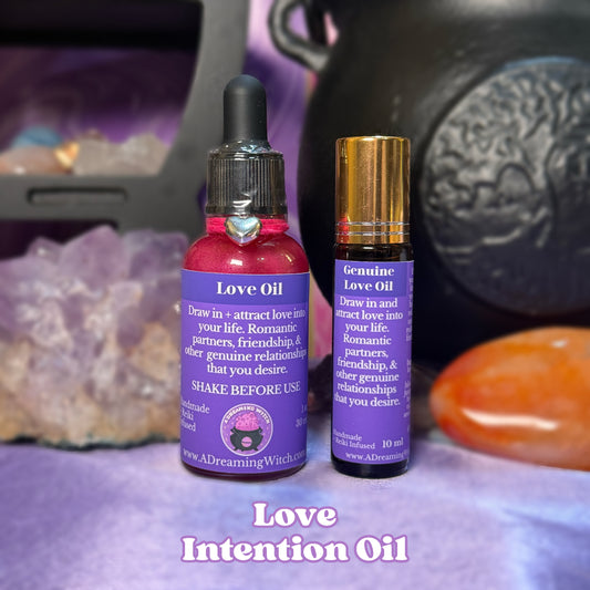 Two bottles of 'Love Intention Oil' with purple labels on a mystical background.