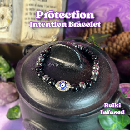 Protection Intention Bracelet with Reiki infusion on a dark surface with mystical elements.
